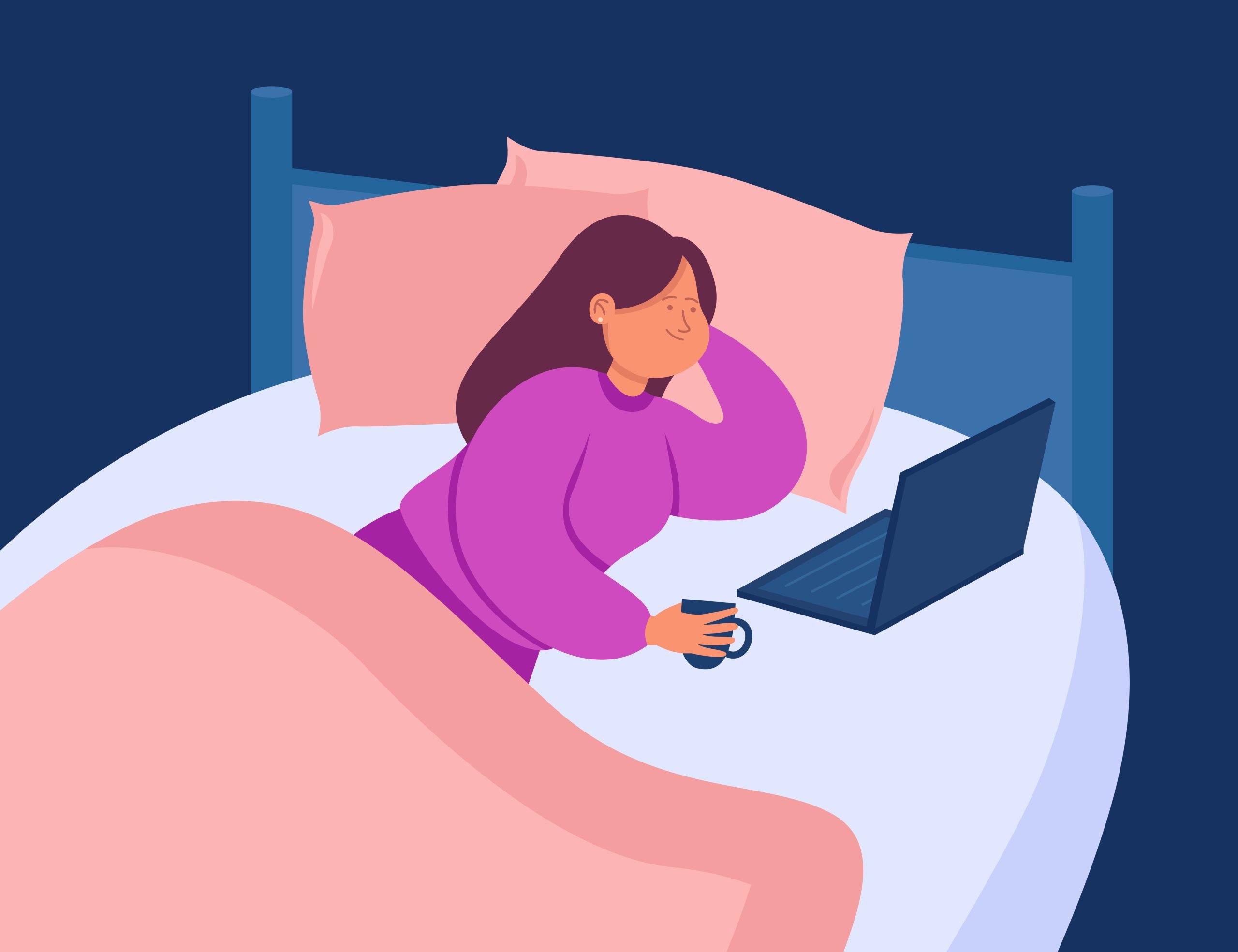 Woman drinking coffee and doing work in bed at home using laptop